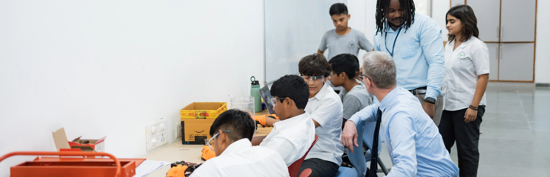 Teachers helping students during a class.